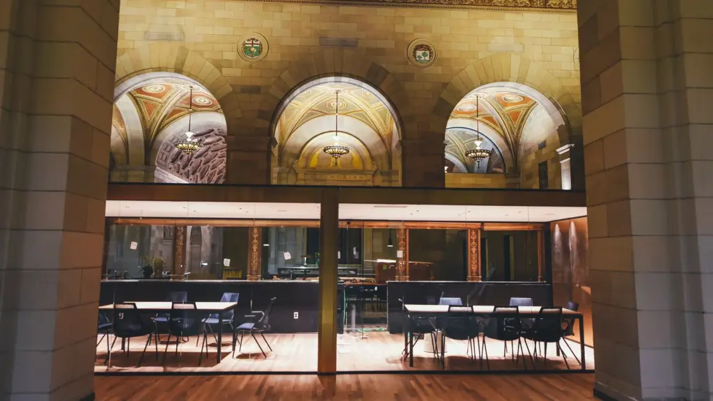 Conference room behind glass in a high-ceilinged hall