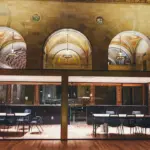 Conference room behind glass in a high-ceilinged hall